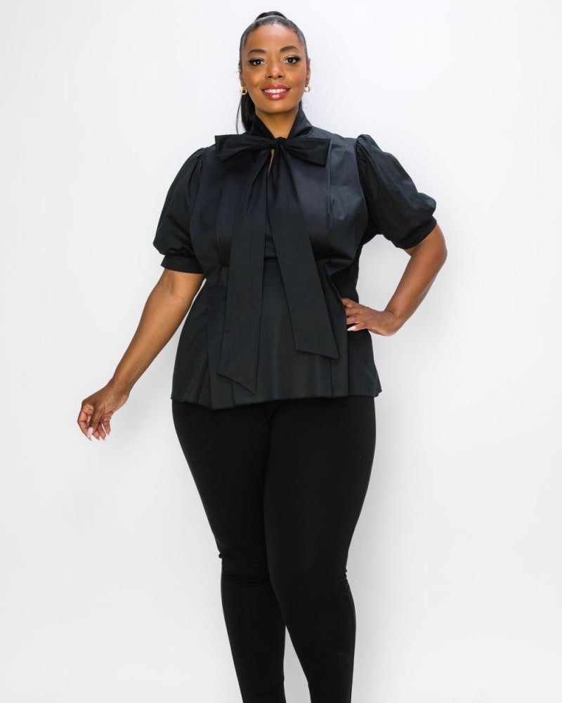 Front of a model wearing a size 1X Ashlyn Tie Neck Blouse in Black by L I V D. | dia_product_style_image_id:240446